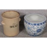 A blue & white ceramic planter along with a stoneware breadbin.