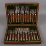 An oak cased canteen of silver plate cutlery.