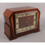 A Norland mahogany cased mantel clock with Arabic numeral markers and Westminster chime.