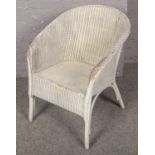 A white lloyd loom chair.