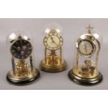 Three German brass torsion clocks, to include Hermle, Schatz, and one other.
