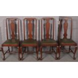 A set of four mahogany queen Anne style dining chairs.