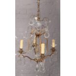 An early 20th century French gilt metal and crystal four branch chandelier along with a quantity