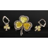 A silver marcasite clover shaped brooch with heart-shaped greenstone inserts, together with matching