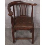 A period oak corner chair with leather inset seat.