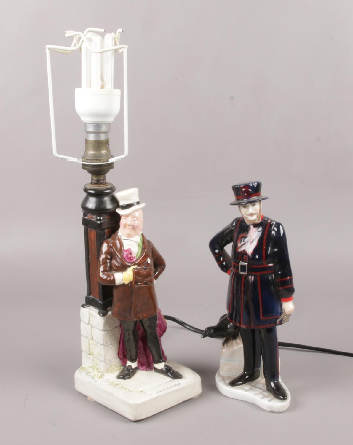 A Bretby figural table lamp, Mr Micawber, along with a Coalport porcelain figure, London Heritage