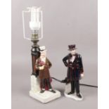 A Bretby figural table lamp, Mr Micawber, along with a Coalport porcelain figure, London Heritage