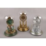 Three German torsion clocks, under glass domes, to include two Kundo and a Koma example.