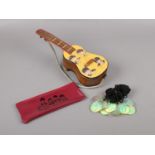 A group of Beatles collectables, a wooden musical guitar box, plastic pencil case, twelve