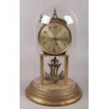 A Kundo Kieninger & Obergfell brass torsion clock under glass dome, height 29cm.