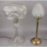 A cut glass table lamp along with a smaller brass and glass example. Chips to edge of glass shade on