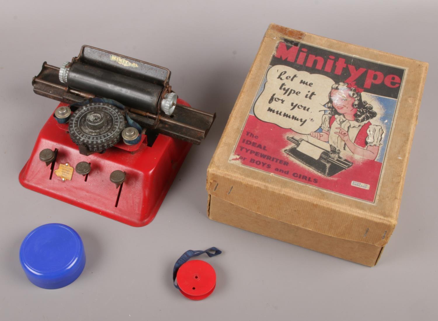 A vintage metal child's Minitype typewriter in original box.