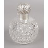 A silver top globular cut glass scent bottle, assayed London 1896 by Sampson Mordan & Co.
