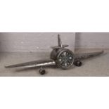 A metal aviation themed wall clock form as a plane. (185cm wide)