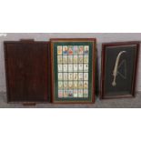 A framed continental dagger in metal sheath along with a oak tray and framed cigarette cards of