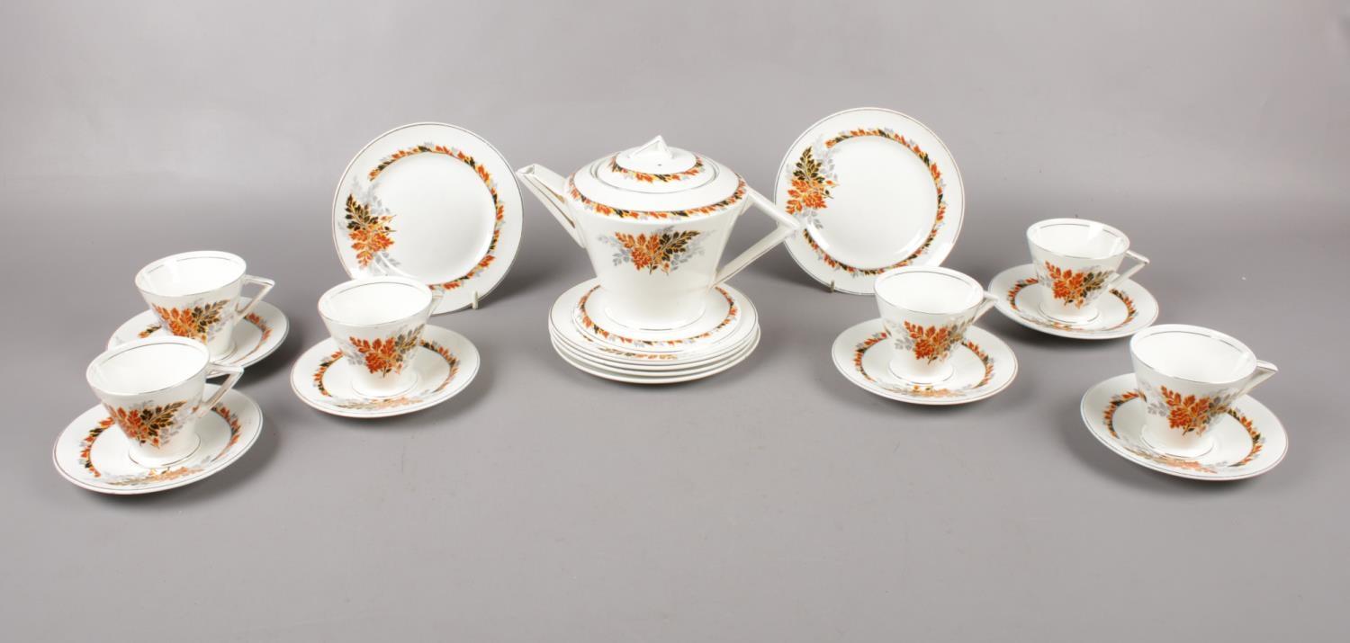 An Art Deco ceramic tea set, teapot, 6 cups & saucers. 6 tea plates.
