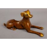 A bronze recumbent dog.