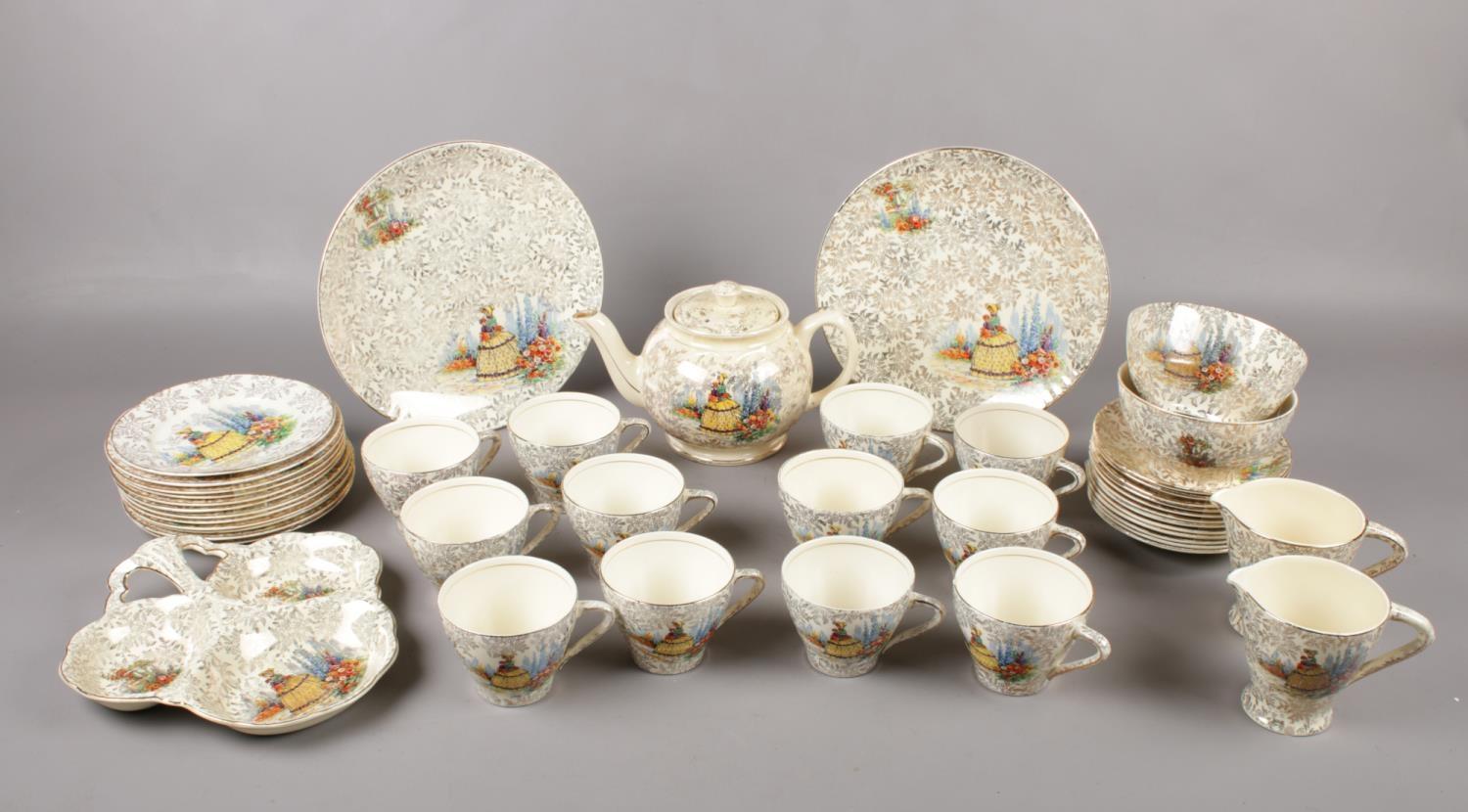 A Empire Shelton Ivory tea service with crinoline lady design. Comprising of, a teapot, two