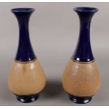 A pair of Royal Doulton stoneware vases. (28cm tall) Damage to base of one vase.