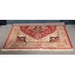 A red ground central medallion wool rug (160cm wide 223cm length)