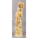 An carved ivory Japanese Meiji period Okimono, formed as a man and his two sons collecting fruit. (