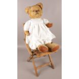 A HML child's folding chair along with a fully jointed teddy with growler.