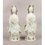 A pair of Chinese blanc de chine Guanyin figures (14cm). Crack to base of one figure, need of a