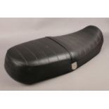 A leather Triumph motorcycle seat.