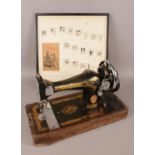 A singer sewing machine along with a framed 1920's singer social activities poster.