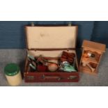 A leather case containing mostly kitchenaila. Including vintage fruit press, flour bin, etc.