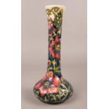 A Moorcroft slim neck vase, decorated in a floral design, boxed. H:20.5cm. Condition good, no cracks