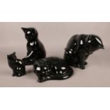 Four ceramics black cats, various sizes and positions.