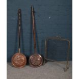 A small selection of metalwares, comprising of two copper bed warmers with wooden handles and a