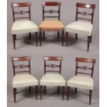 A set of six Regency mahogany dining chairs. With reeded cresting rails supported on reeded uprights