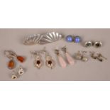 Nine pairs of silver earrings.