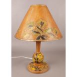 A 1940s wooden based table lamp with painted floral design and gilt borders. New wiring.