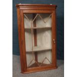 An Oak corner display wall unit with glazed door and metal pull handle. H-61.5cm, W- 48cm, D-35.5cm.