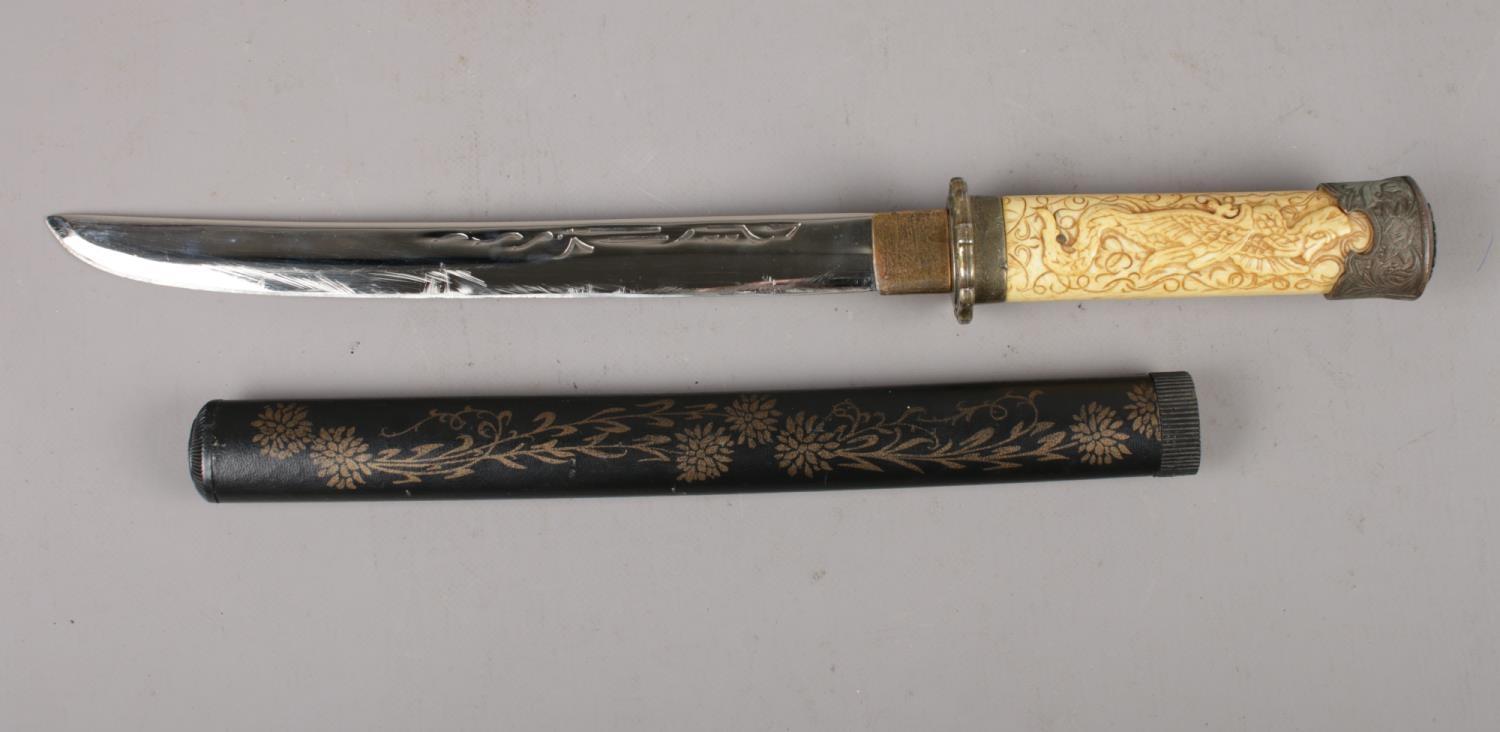 A reproduction Japanese Wakizashi short sword. (28cm blade). Dragon decoration to the handle and