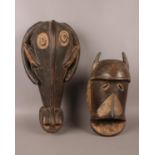 Two African hardwood wall carvings. Comprising of a tribal mask and possibly a water buffalo. Mask -
