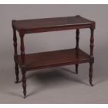 A Regency mahogany two-tier buffet side table raised on turned supports and terminating on brass