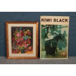 A framed picture of a floral needlepoint tapestry together with a metal advertising sign for Kiwi