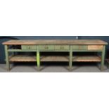 A large painted pine kitchen preparation table. (84.5cm x 288cm x 67.5cm) Missing one drawer, two