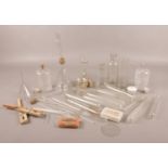 A collection of vintage chemistry equipment. Includes conical flasks, funnel, test tubes etc.