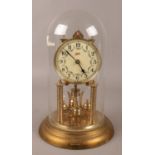 A Schatz brass torsion clock under glass dome. (30cm).