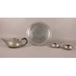 A Lion pewter hammered three piece tea service. Comprising of a teapot with Bakelite handle, cream
