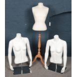 Three mannequin female torso shop displays.