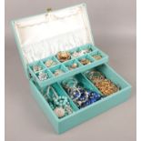 A cantilever jewellery box of costume jewellery. Including beads, necklaces, brooches, etc.