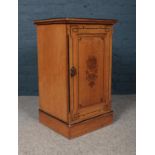 A Victorian side cabinet with painted ebonised decoration on the top and door. (Height 75cm, width