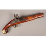 A carved hardwood and brass flint lock pistol. (approximately 40cm). Good condition. Action