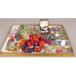 A large tray of costume jewellery to include necklaces, beads, etc.